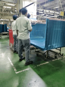 workers in a factory with a sign on the wall that says ' assembly line '