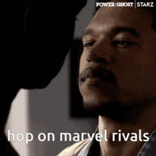 a close up of a man 's face with the words hop on marvel rivals on the bottom