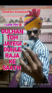 a man wearing a turban and sunglasses taking a selfie