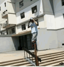 a man riding a skateboard on a railing in front of a building that says ' a few steps down '