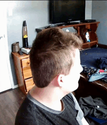 a man is sitting in front of a samsung television