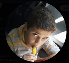 a young boy is eating a banana with a circle around him that says aerts @greens on it