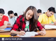 a group of young students are sitting at desks in a classroom .