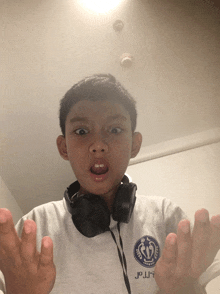 a boy wearing headphones and a shirt that says jpjpy