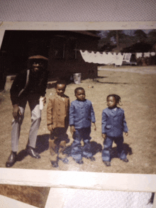 a man and three children pose for a picture in front of a white tent