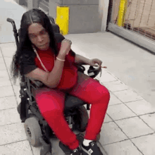 a woman is sitting in a wheelchair in a parking garage .