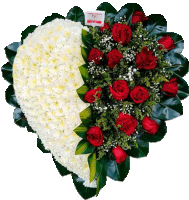 a heart shaped arrangement of red roses and white flowers with a card that says ' flores ' on it