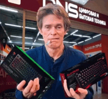 a man is smoking a cigarette while holding a keyboard and a mouse