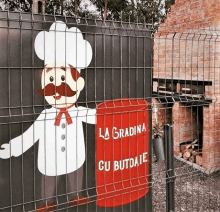 a fence with a chef on it and the words la gradina cu butoaie