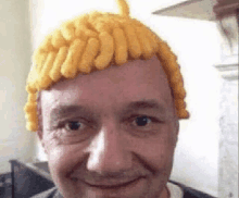 a man is wearing a wig made out of french fries .