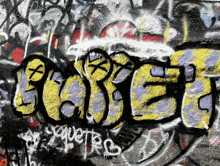 graffiti on a wall that says " babe " in yellow and purple