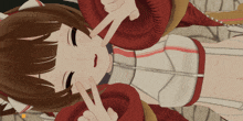 a girl in a red and white outfit is laying down and giving a peace sign