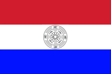 a red white and blue flag with a circular design in the center