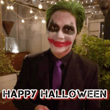 a man in a joker costume with the words happy halloween below him