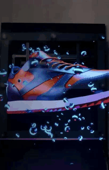 a shoe is displayed on a screen with bubbles around it