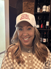 a woman wearing a white hat that says corks are for quitters