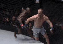 two men are fighting in a boxing ring and one is running away from the other