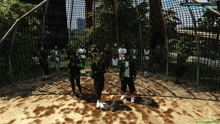 a group of people standing in front of a fence with a screenshot of a video game showing a score of 88 points