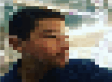 a pixelated image of a man with a blue shirt