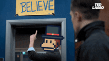 a man points to a sign that says believe on it