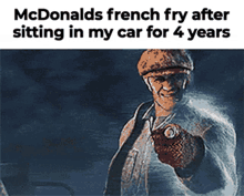 a picture of a man sitting in a car with the caption mcdonald 's french fry after sitting in my car for 4 years