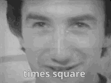 a black and white photo of a man 's face with the words `` times square '' written above it .