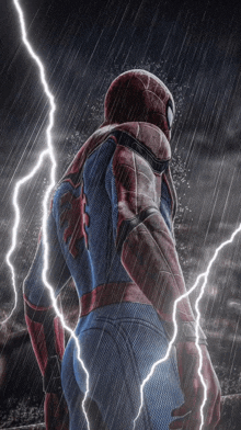 a man in a spiderman costume is standing in the rain with lightning behind him