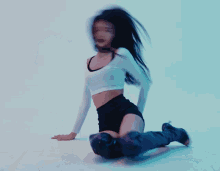 a woman with long black hair is kneeling down on the floor