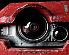 a close up of a red car with the words " i n-n-never got to see you "