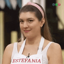 a woman wearing an apron with the name estefania on it .