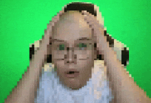 a pixelated image of a man holding his head with his hands