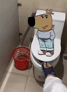 a person 's foot is on a toilet with a cartoon bear on it