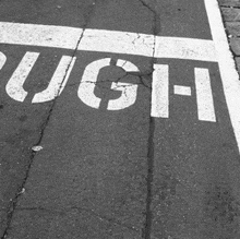 a black and white photo of a street with the word push written on it