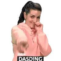 a woman in a pink hoodie is pointing at the camera and has the word dasding on the bottom right