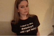 a girl wearing a black shirt that says i used to like skaterboys until i got help