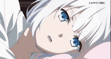 a girl with white hair and blue eyes is laying in bed