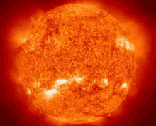 a close up of the sun with a red background