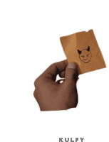 a hand is holding a piece of paper with a devil on it .