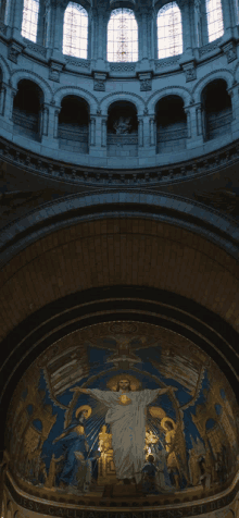 the inside of a church with a painting of jesus on the cross on the ceiling