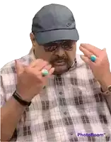 a man wearing a plaid shirt and a nike hat shows off his rings on his fingers