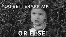 a black and white photo of a little girl pointing at something with the words `` you better see me or else ! ''