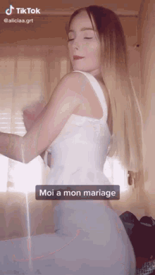 a woman in a white dress with the words moi a mon mariage on the bottom right