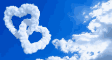 two hearts made out of clouds in the blue sky