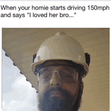 a man with a beard wearing a hard hat and safety glasses