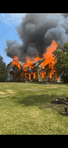 a house is on fire with smoke coming out of the roof