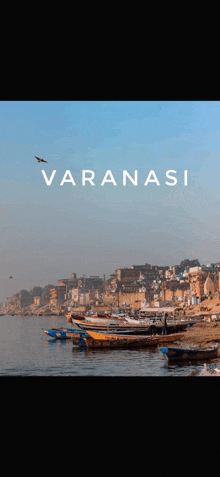 a poster for varanasi with boats in the water and a city in the background