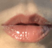 a close up of a woman 's lips with a glossy finish