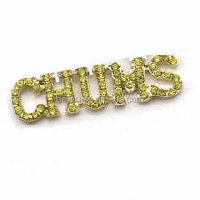 the word chuns is surrounded by green rhinestones .