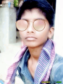 a boy wearing sunglasses and a scarf has the website insertface.com on the bottom