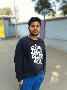 a man wearing a black sweatshirt that says born free fight